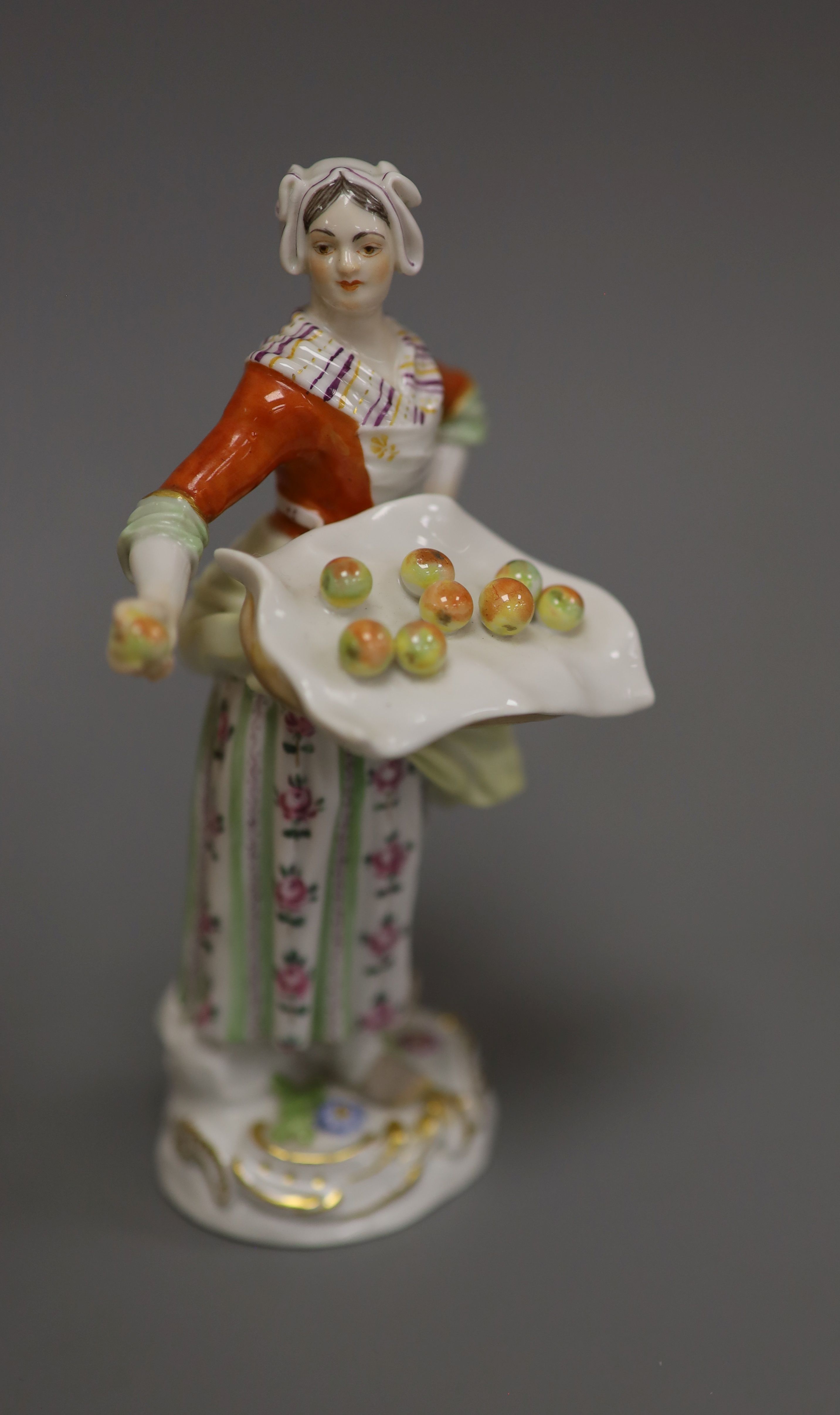 A late Meissen porcelain figure of a girl selling apples, H 14cm